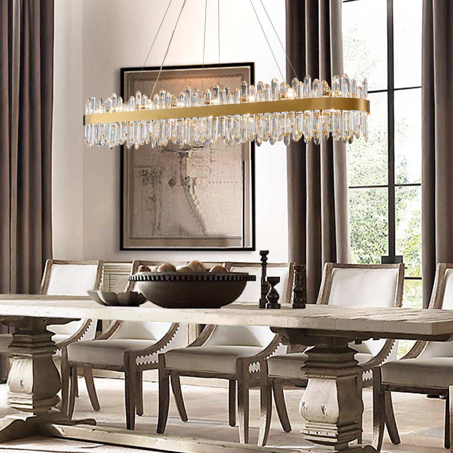 Rectangular gold chandelier above long dining table