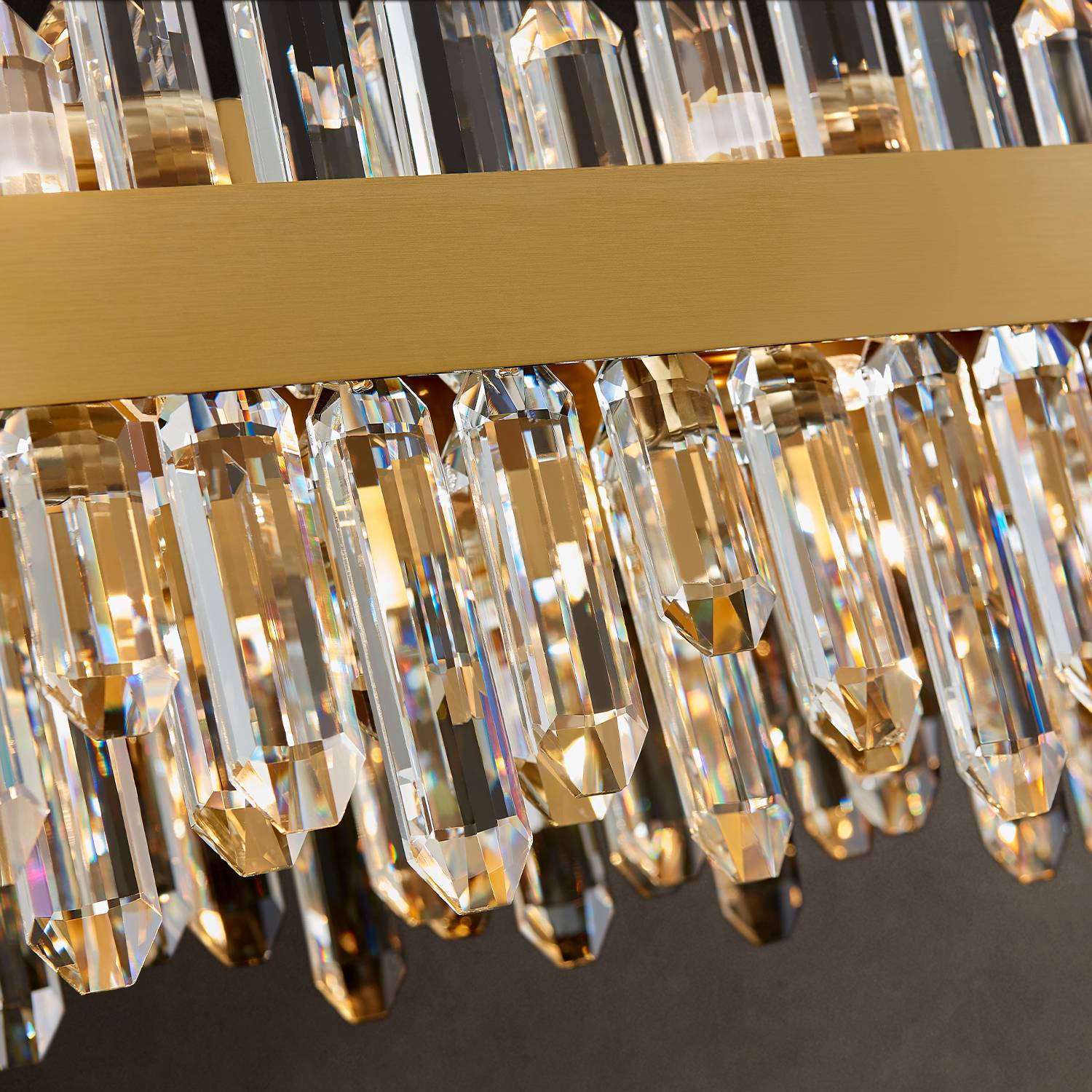 Close-up of gold frame and K9 crystal prisms on rectangular chandelier