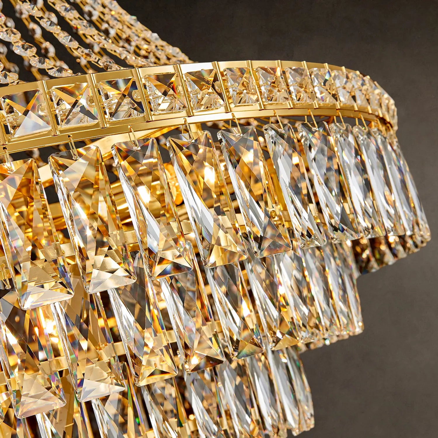 Close-up of gold frame and K9 crystal prisms on large chandelier