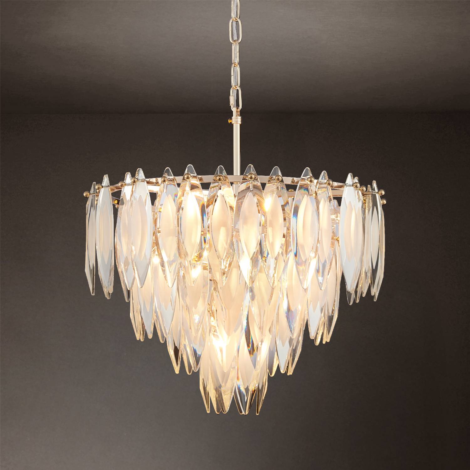 Medium gold K9 crystal chandelier hanging on dark background