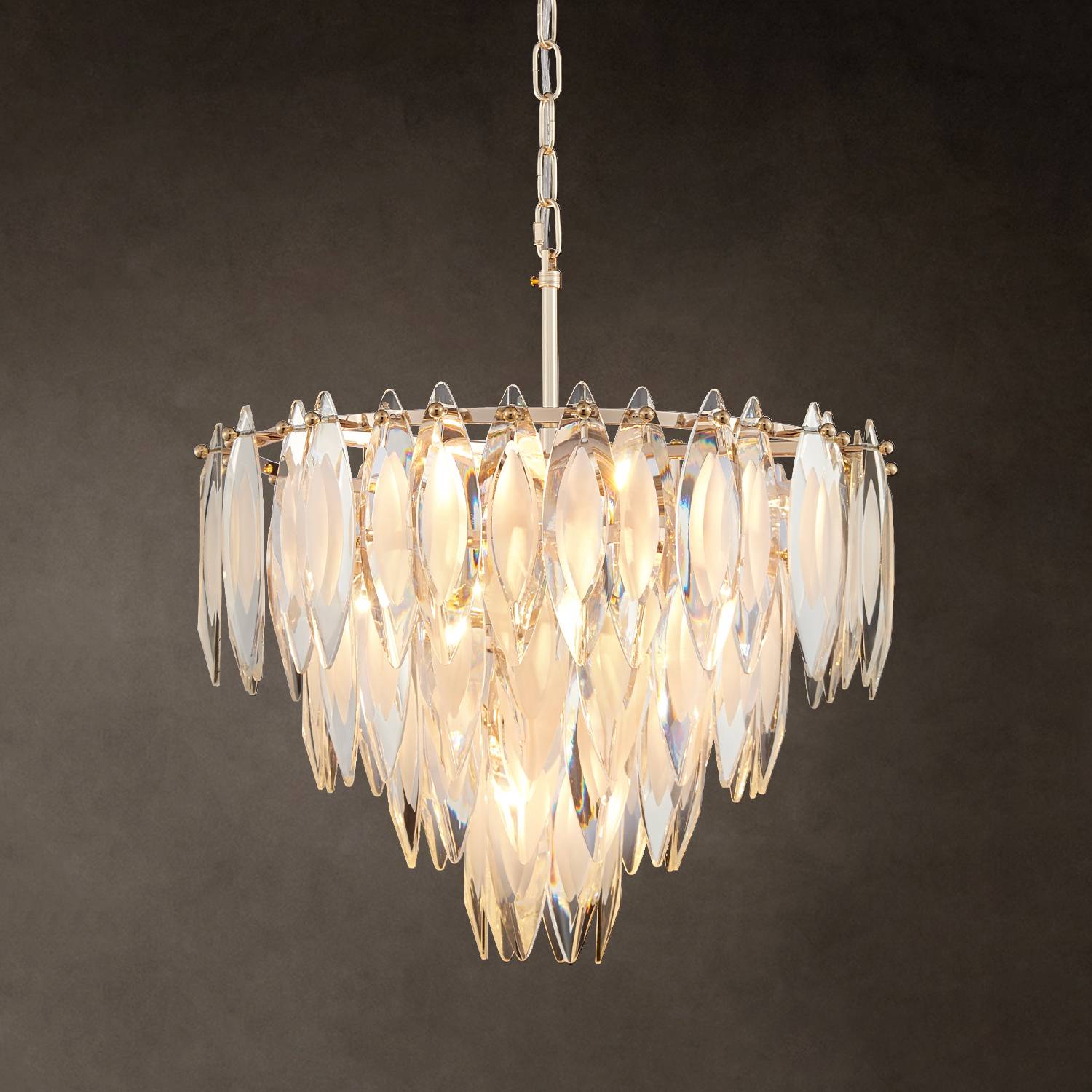 Medium gold K9 crystal chandelier hanging on dark background