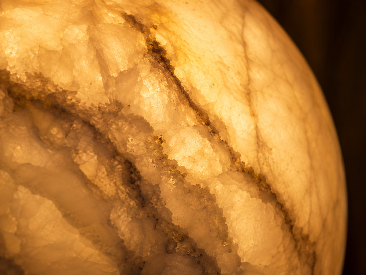 Close-up of glowing alabaster stone shade showing natural veining, Esperilux alabaster lighting