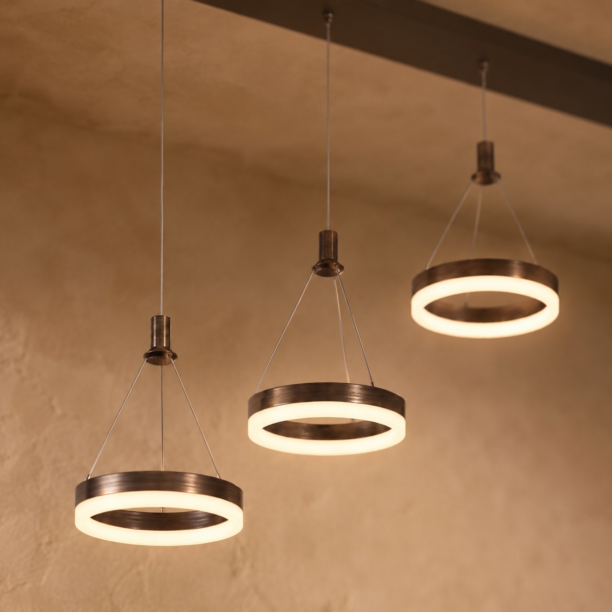 Aitu linear LED chandelier in gold with round light heads glowing warm white