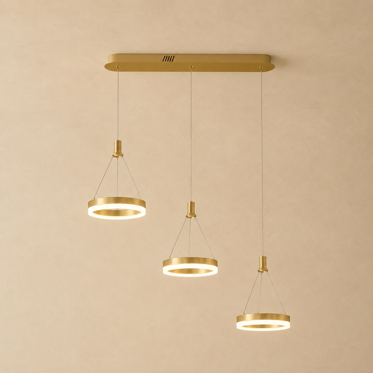 Aitu linear LED chandelier in gold with round light heads glowing warm white