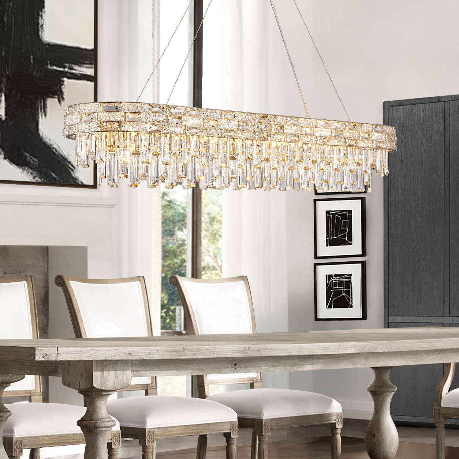 Oval gold chandelier above long dining table
