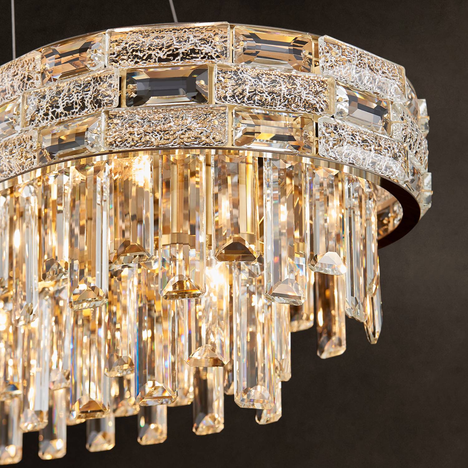 Close-up of gold frame and K9 crystal prisms on oval chandelier