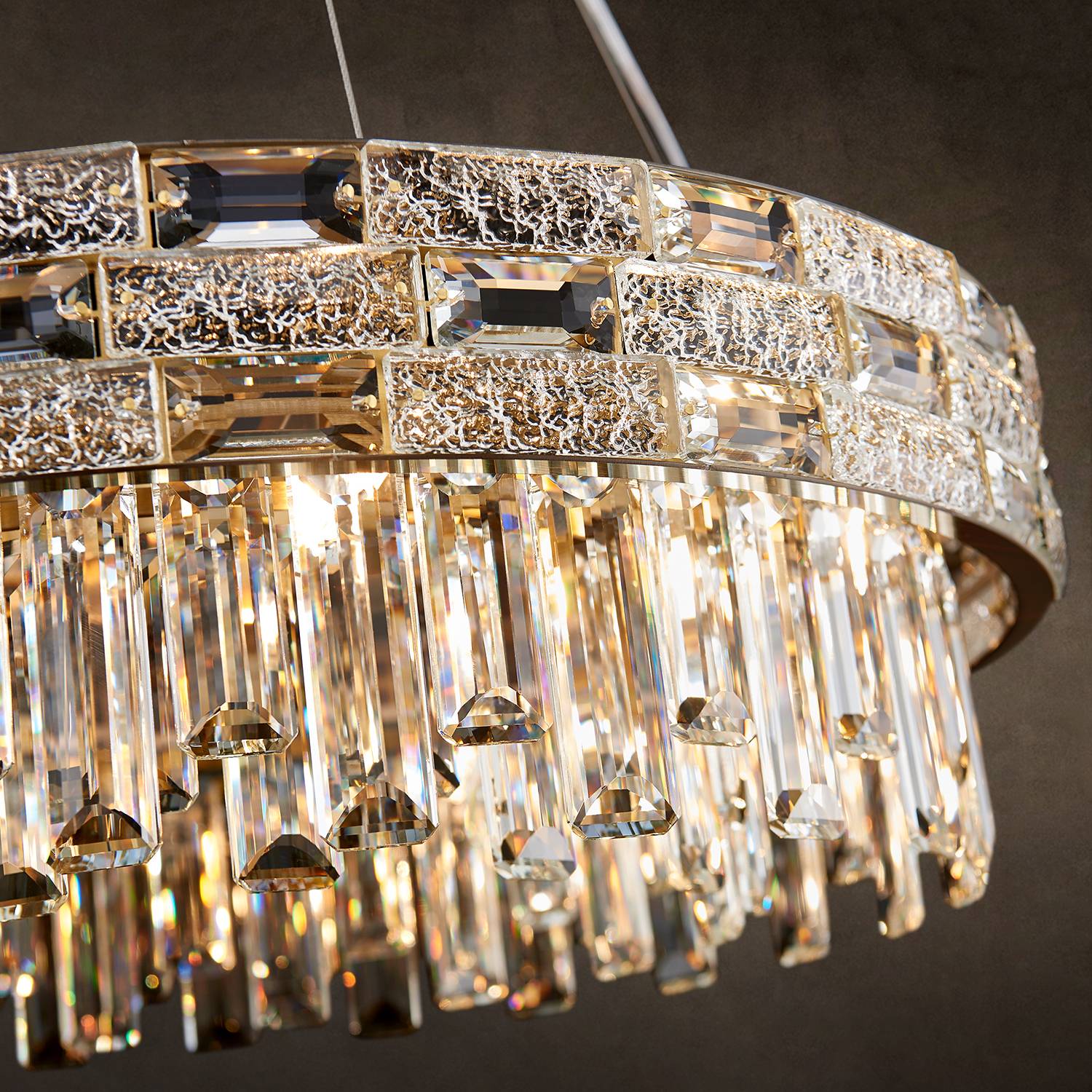 Close-up of gold frame and K9 crystal prisms on round chandelier