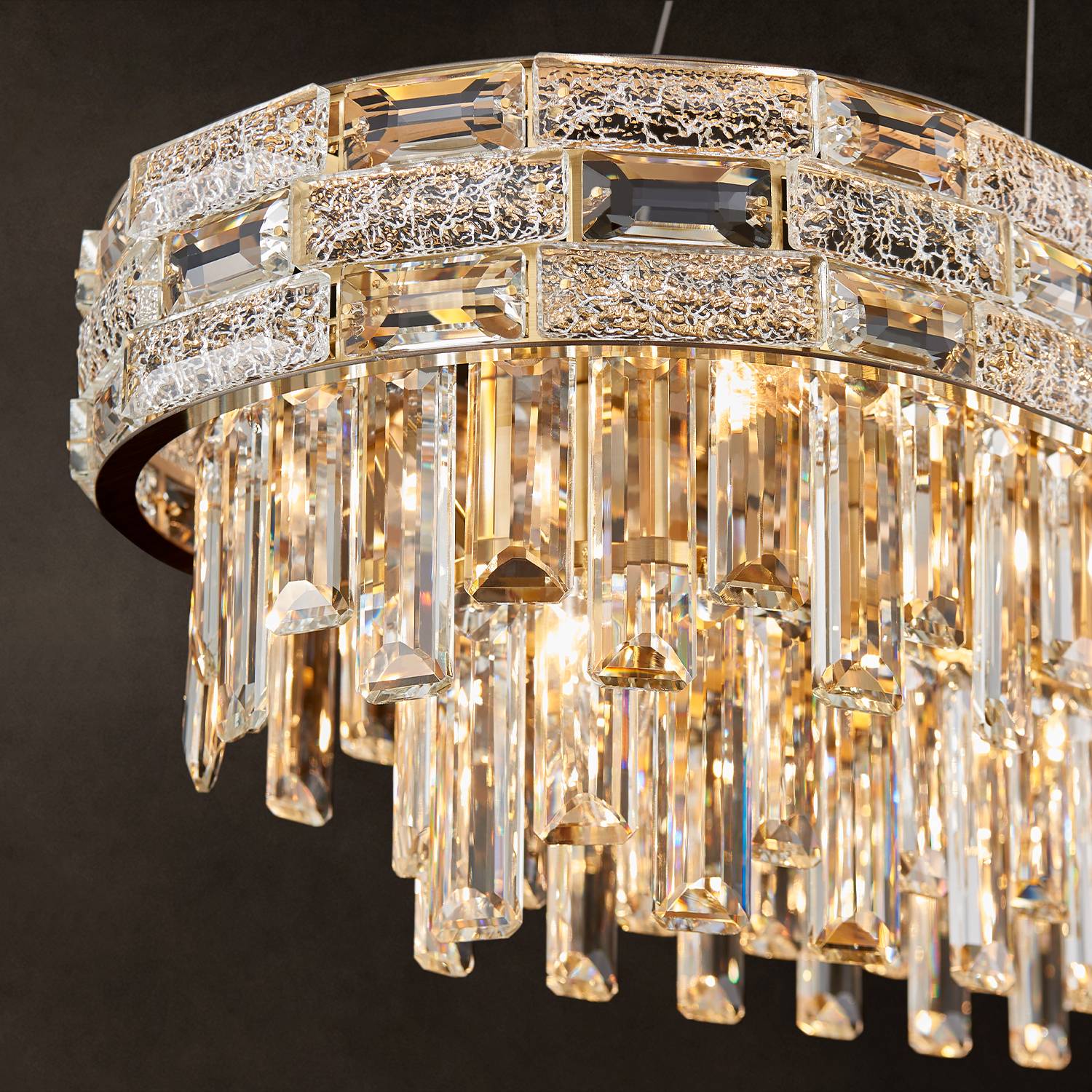 Close-up of gold frame and K9 crystal prisms on oval chandelier