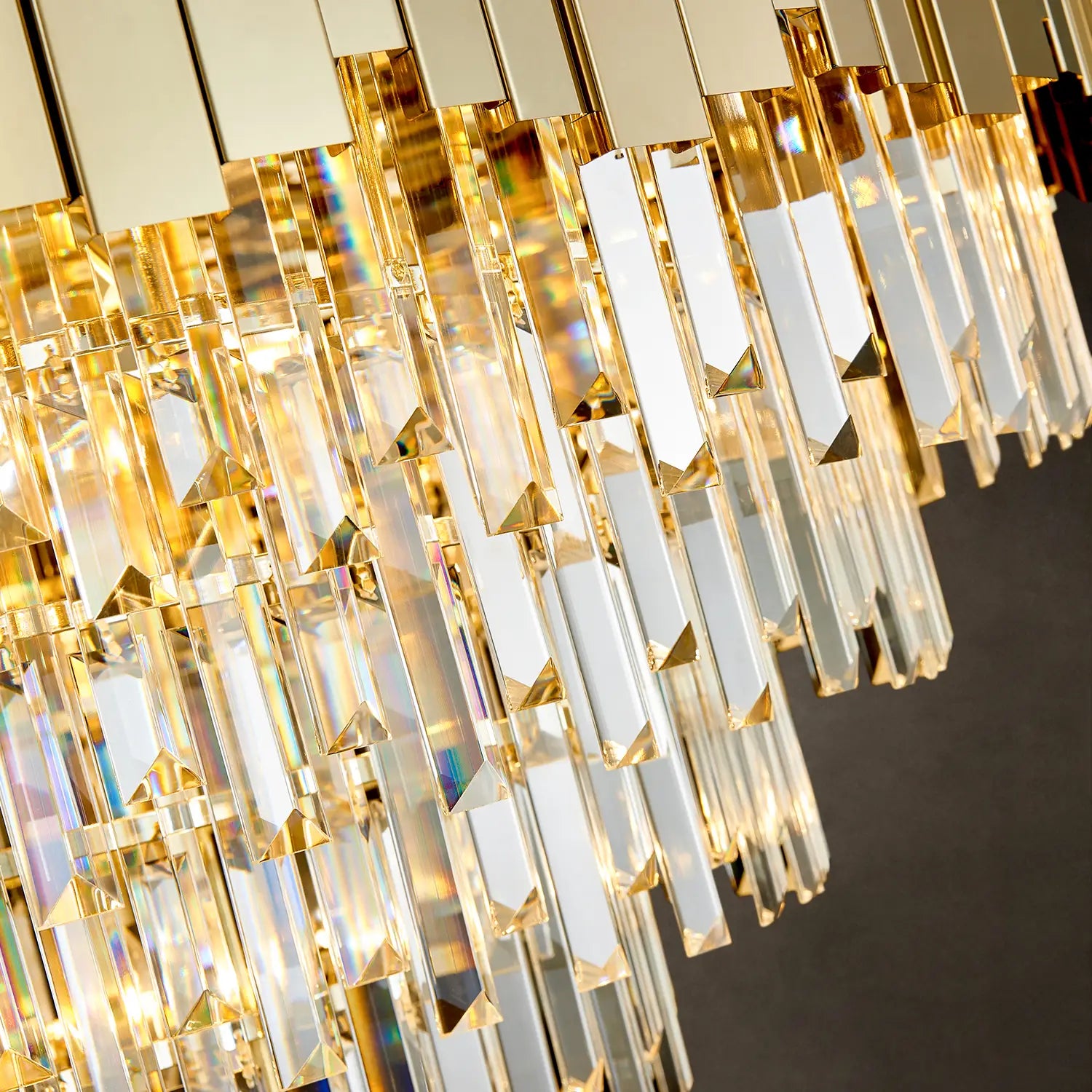 Close-up of gold frame and K9 crystal prisms on large chandelier
